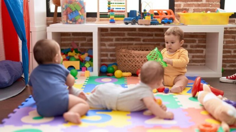 group-toddlers-playing-with-toys-crawling-floor-kindergarten_839833-28001